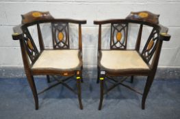 A PAIR OF EDWARDIAN MAHOGANY AND MARQUETRY INLAID CORNER CHAIRS, with a shaped back rest, cream