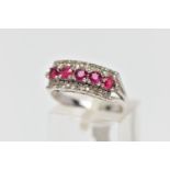 A WHITE METAL RUBY AND DIAMOND DRESS RING, designed as three rows, the central row set with five