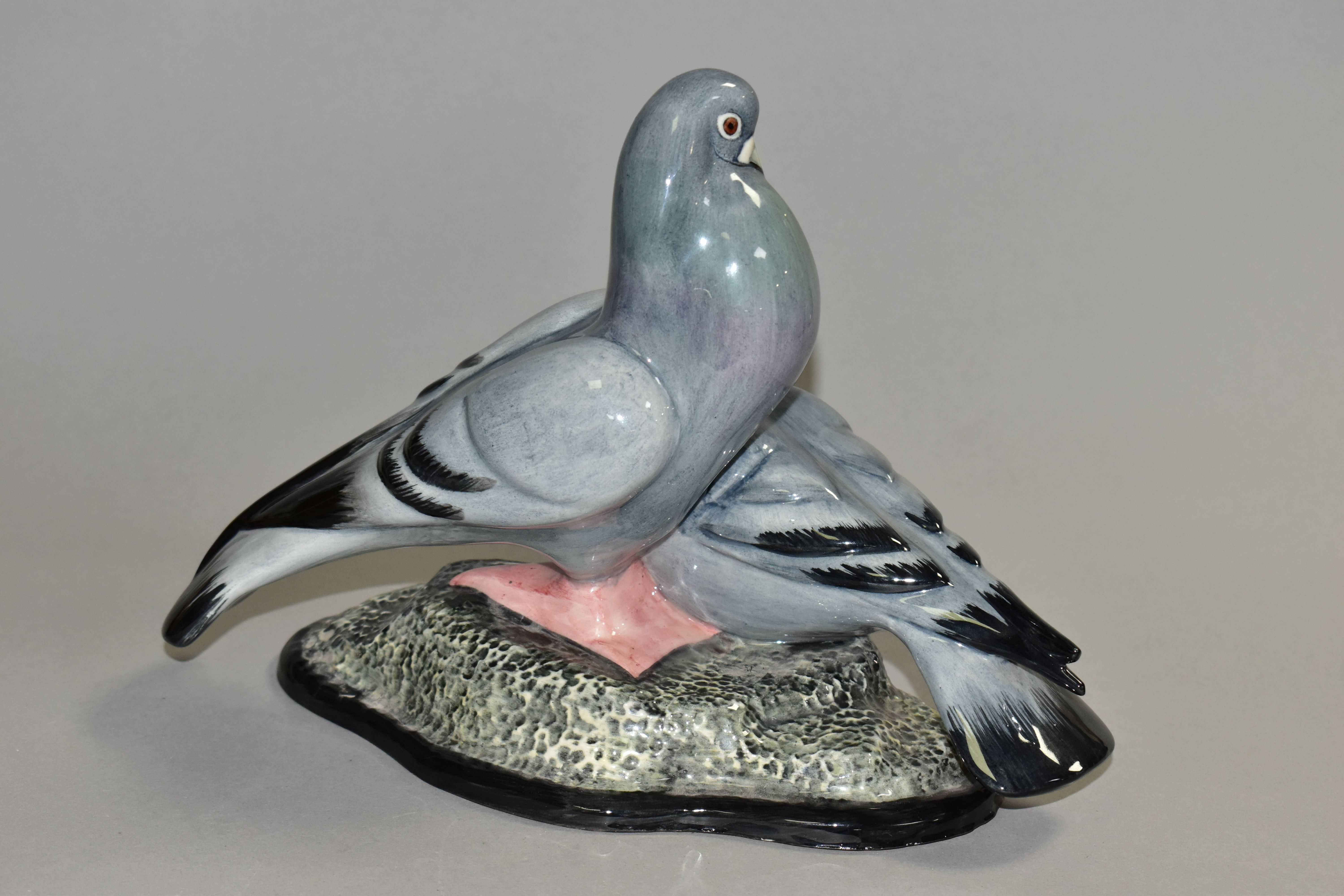 A CARLTON WARE FIGURE GROUP OF TWO PIGEONS, modelled as standing on a rocky base, printed marks