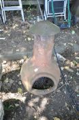 A TERRACOTTA CHIMINEA, with domed metal lid, on a separate metal base, diameter 140cm x height 102cm