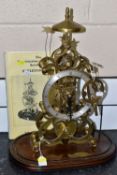 A LATE 20TH CENTURY DENNIS SMITH BRASS SKELETON CLOCK OF SCROLLED FORM, the silvered chapter ring