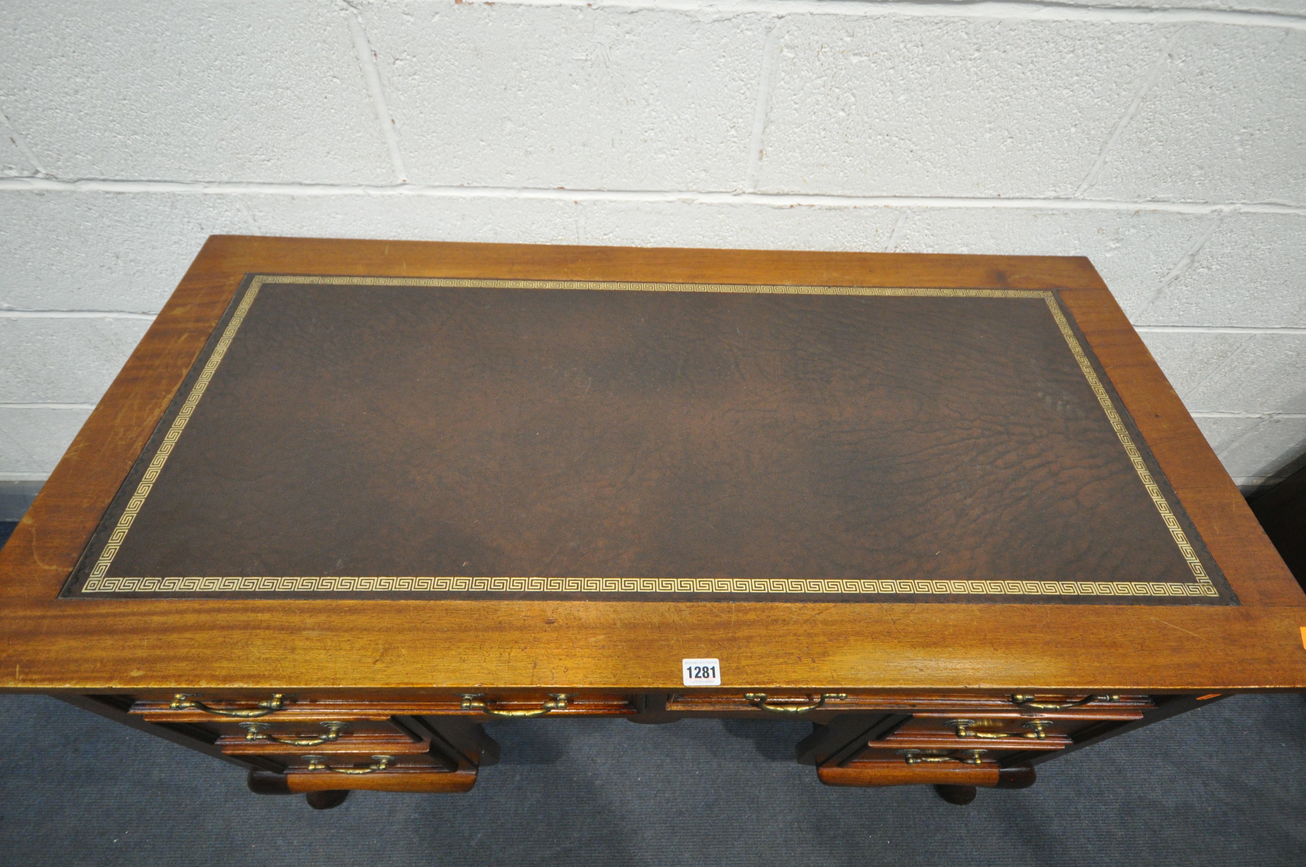 A 20TH CENTURY MAHOGANY KNEE HOLE DESK, with brown tooled leather inlay, an arrangement of six - Image 2 of 4