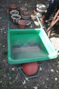 A GREEN PLASTIC BALLBORROW WHEELBARROW