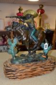 A BRONZE FIGURE OF A MEXICAN COWBOY ON HORSEBACK, on a soft wooden base, height 35cm x width 31cm,
