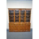 A YEW WOOD BREAKFRONT BOOKCASE, with four drawers, width 202cm x depth 52cm x height 211cm x