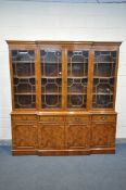 A YEW WOOD BREAKFRONT BOOKCASE, with four drawers, width 202cm x depth 52cm x height 211cm x