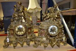 TWO 20TH CENTURY BRASS CASED FIGURAL MANTEL CLOCKS, one surmounted with a couple, the other with a