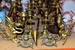 A GROUP OF BRASS CANDLESTICKS, fourteen pieces to include six candlesticks in the form of dragons, a