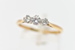 A MID 20TH CENTURY PLATINUM AND 18CT YELLOW GOLD DIAMOND THREE STONE RING, set with a principal