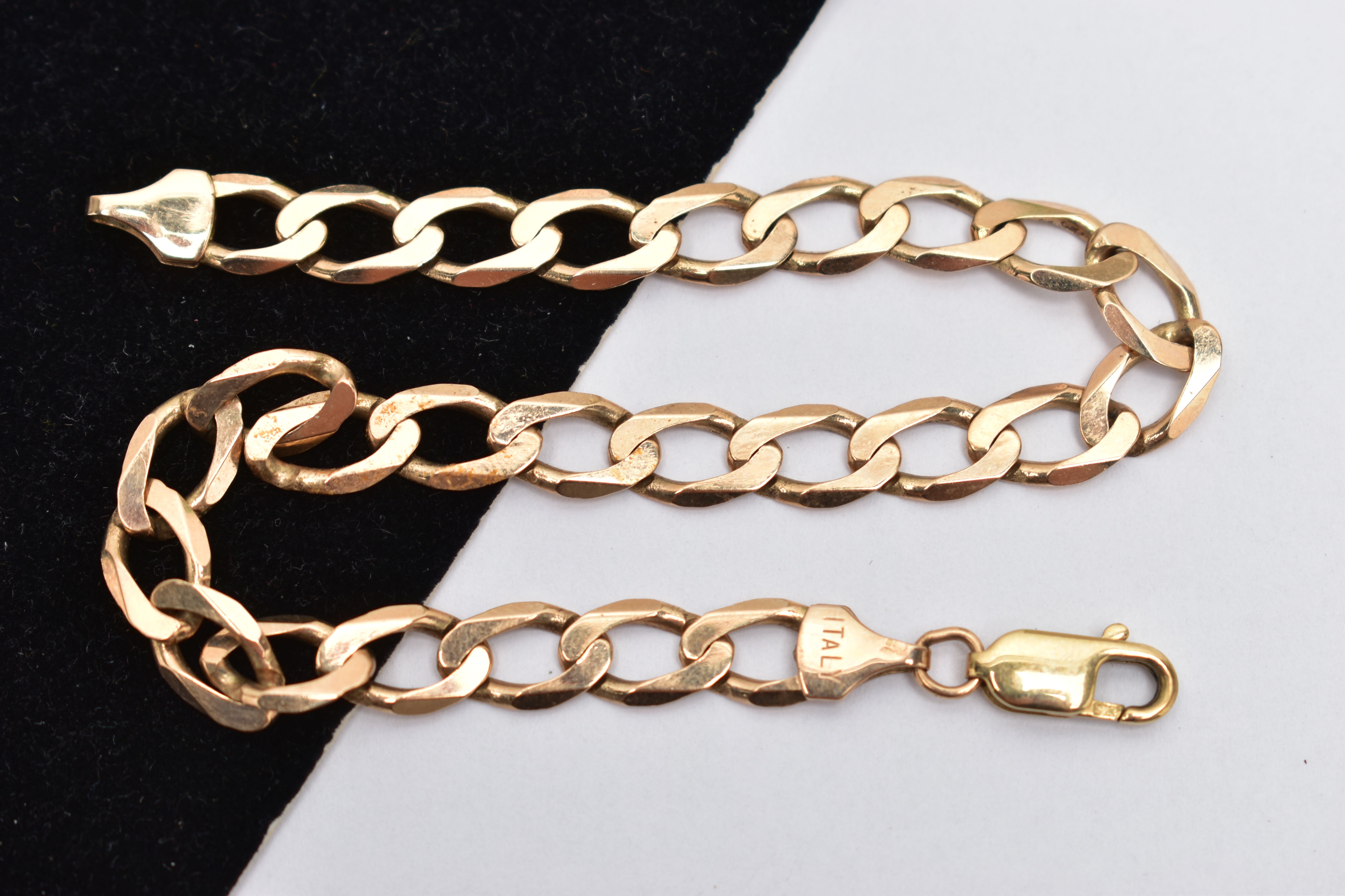 A 9CT YELLOW GOLD BRACELET, designed as a flat curb link chain with lobster clasp, approximate