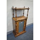 A VICTORIAN WALNUT SERPENTINE MUSIC CABINET, the raised top supported by turned uprights, over a