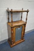 A VICTORIAN WALNUT SERPENTINE MUSIC CABINET, the raised top supported by turned uprights, over a