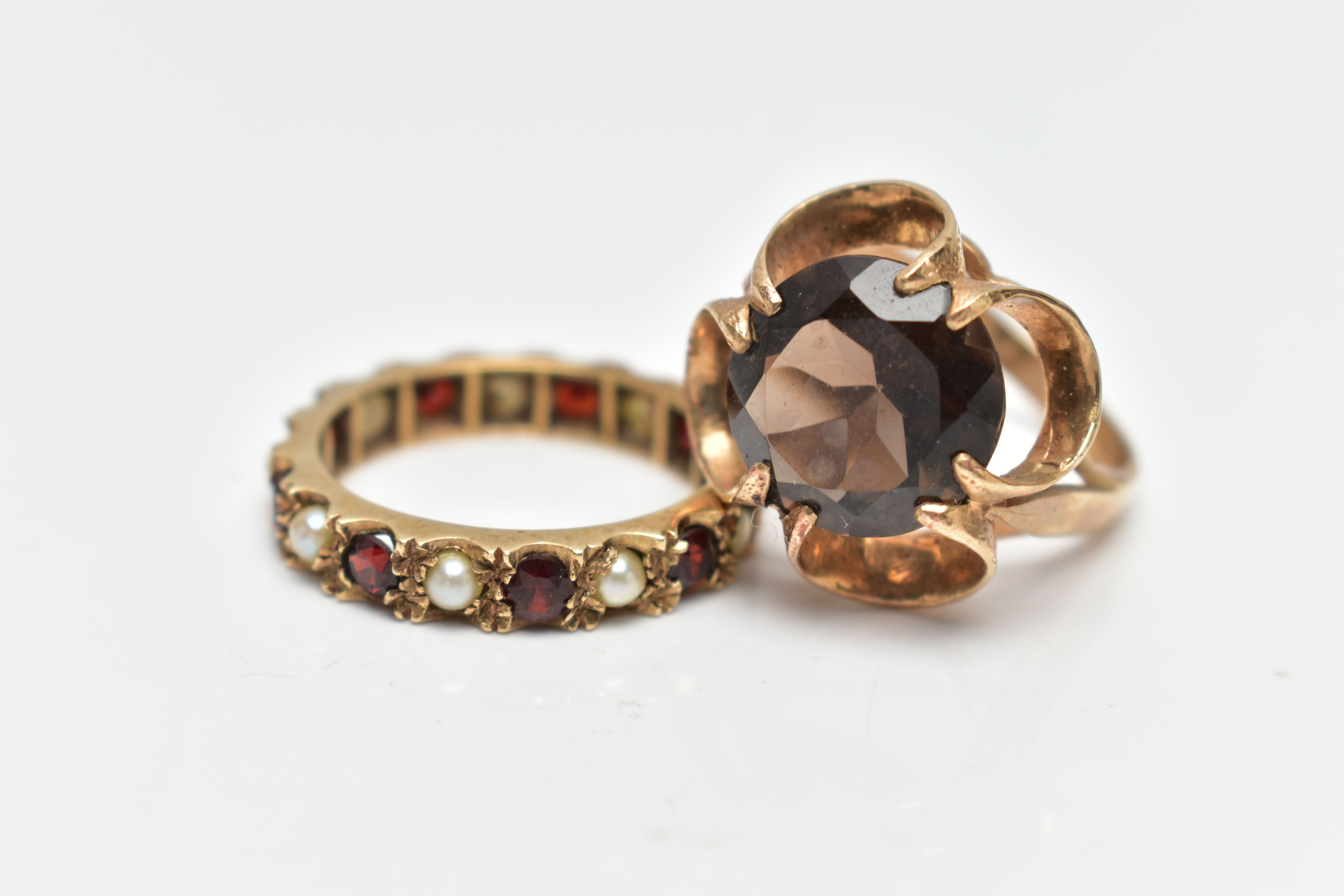 TWO YELLOW METAL GEM SET RINGS, to include a 1970s smokey quartz single stone ring, hallmarked