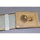 AN EARLY 20th CENTURY PHOTOGRAPH ALBUM, featuring approximately ninety-two images of people,