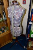 AN ADJUSTABLE DRESSMAKER'S MANNEQUIN, female form, in paisley print fabric, raised on a wooden