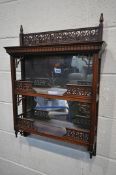 A 20TH CENTURY WALNUT TWO TIER WALL SHELF, with a mirrored back and open fretwork detail, width 54cm