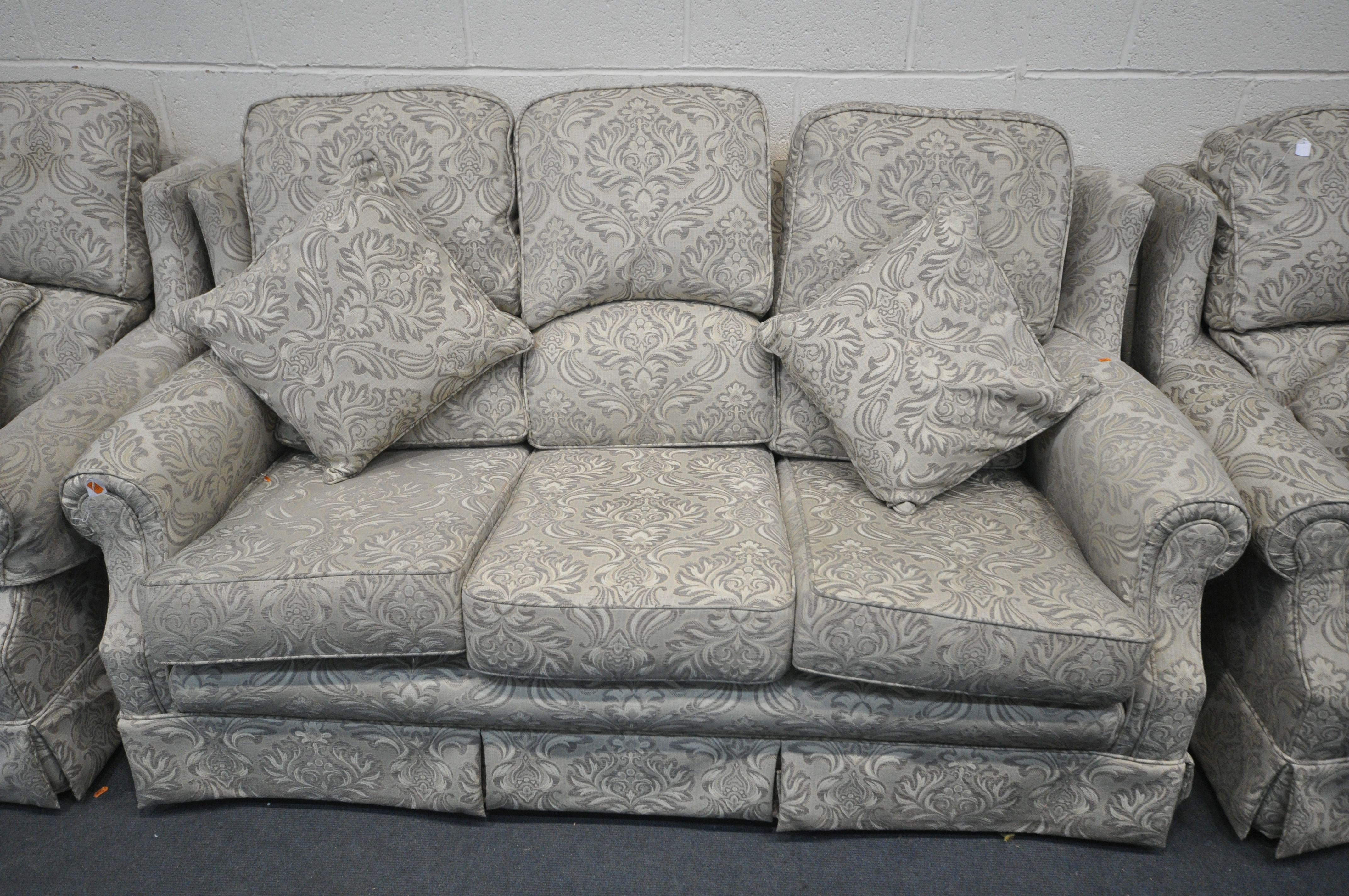 A FLORAL UPHOLSTERED THREE PIECE LOUNGE SUITE, comprising a three seater settee, and a pair of - Image 2 of 3
