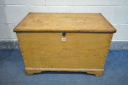 A 19TH CENTURY PINE BLANKET CHEST, enclosing an internal candle box, with twin handles, on bracket