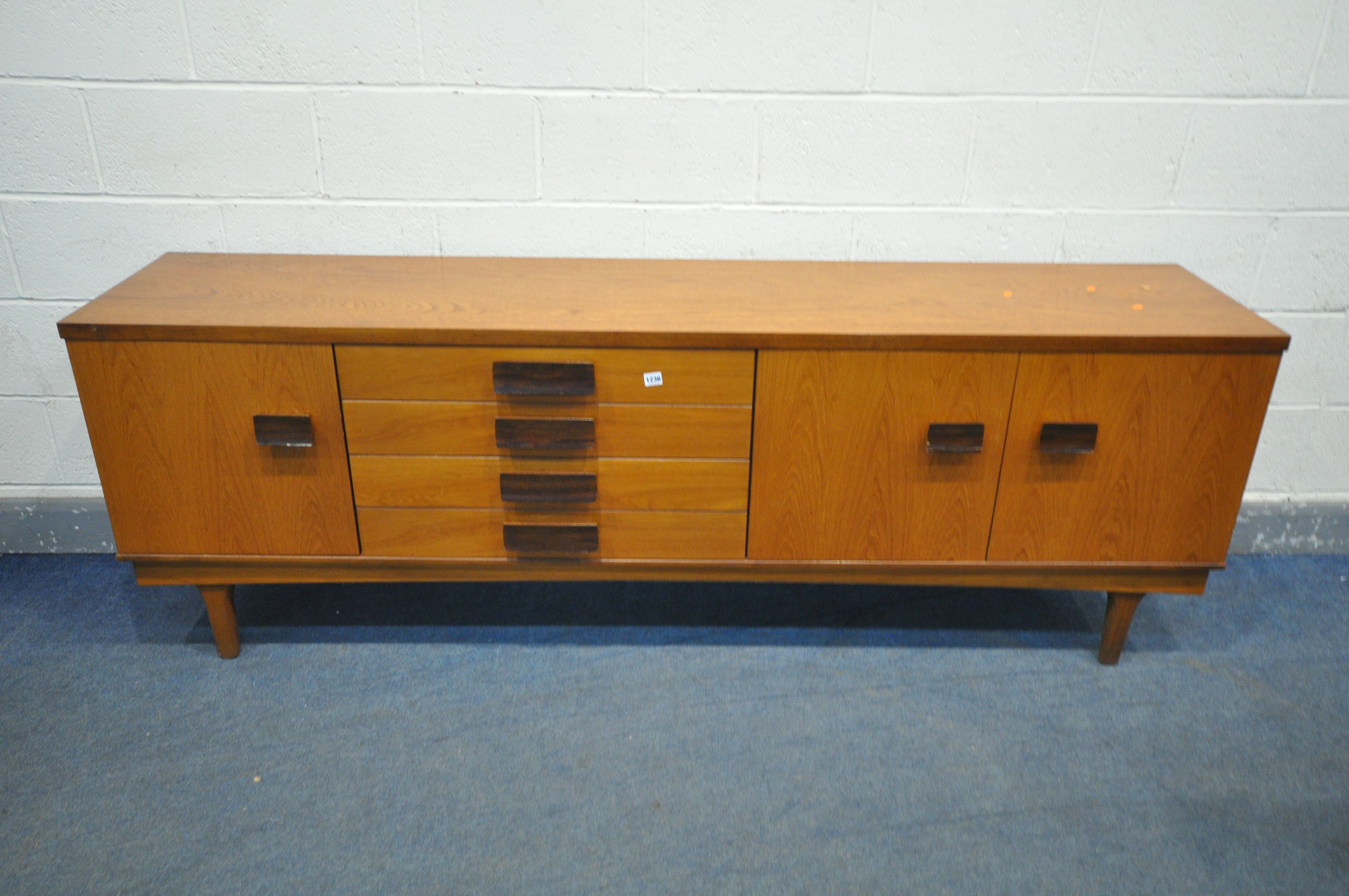 A BATH CABINET MAKERS 1960'S TEAK SIDEABOARD, with a single and double cupboard doors that a both