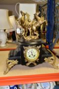 A LATE 19TH CENTURY BLACK SLATE AND GILT METAL FIGURAL MANTEL CLOCK, the case surmounted by two