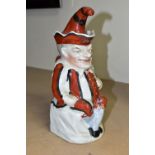 A STAFFORDSHIRE TOBY JUG IN THE FORM OF MR PUNCH, with red, black and white striped outfit, the