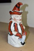 A STAFFORDSHIRE TOBY JUG IN THE FORM OF MR PUNCH, with red, black and white striped outfit, the