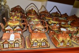 A LARGE QUANTITY OF COTTAGEWARE TEAPOTS, BUTTER DISHES AND BISCUIT BARRELS, comprising twenty six