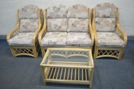 A WICKER CONSERVATORY SUITE, comprising a sofa, pair of armchairs and a glass top coffee table (4)