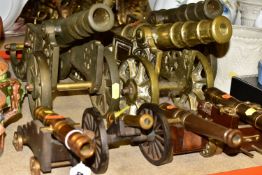 SEVEN BRASS ORNAMENTAL CANNONS, two matching cannons, length 47cm x width 15cm, one solid brass