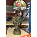 A TIFFANY STYLE LAMP, lamp base is of a young Grecian couple, the male figure is holding the shade