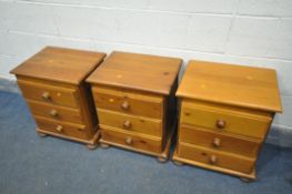 A PAIR OF PINE THREE DRAWER BEDSIDE CABINETS, and a similar three drawer bedside cabinet (3)