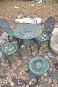A GREEN PAINTED ROUND ALUMINIUM GARDEN TABLE 70cm in diameter, three similar chairs and a similar