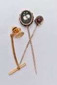 TWO STICK PINS, A PIN BADGE AND A LOOSE DIAMOND, to include a yellow metal oval Pietra dura floral