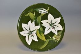 A MOORCOFT CHARGER DECORATED WITH WHITE LILIES ON A GREEN GROUND, bears impressed factory mark,