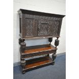 AN 17TH/18TH CENTURY CARVED OAK BUFFET, the top having a single cupboard door, over two shelves,