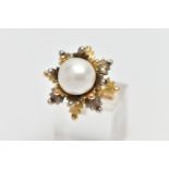 A WHITE AND YELLOW METAL CULTURED PEARL RING, of foliate design, set with a principal part drilled
