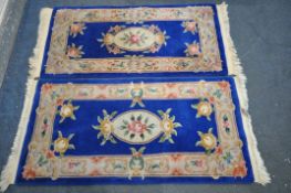 TWO BLUE AND CREAM CHINESE WOLLEN RUGS, 149cm x 79cm