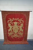 A FABRIC WALL TAPESTRY of a gold coat of arms within a red field, on a wrought iron pole, 175cm x