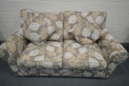 A BROWN FLORAL UPHOLSTERED TWO SEATER BED SETTEE, length 180cm