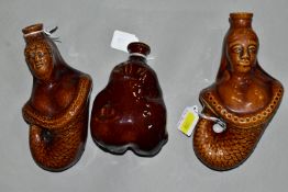 TWO VICTORIAN TREACLE GLAZED FLASKS IN THE FORM OF MERMAIDS, heights 20cm and 18cm and another