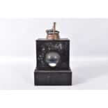 A RAILWAY HAND LAMP, reservoir, burner and wick to base, clear bullseye lens, copper chimney,