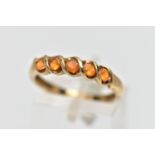 A 9CT GOLD FIRE OPAL FIVE STONE RING, the circular cut fire opals within a partial twist collet