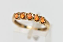 A 9CT GOLD FIRE OPAL FIVE STONE RING, the circular cut fire opals within a partial twist collet