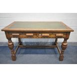A 20TH CENTURY SOLID OAK WRITING DESK, with green leather inlay, two frieze drawers, on acorn