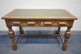 A 20TH CENTURY SOLID OAK WRITING DESK, with green leather inlay, two frieze drawers, on acorn