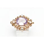 A MID 20TH CENTURY 9CT GOLD AMETHYST AND CUBIC ZIRCONIA BROOCH, the oval claw set amethyst, within