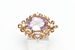 A MID 20TH CENTURY 9CT GOLD AMETHYST AND CUBIC ZIRCONIA BROOCH, the oval claw set amethyst, within