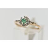 A 9CT GOLD EMERALD AND DIAMOND CLUSTER RING, set with a circular cut emerald, within a round