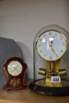 A BOXED JUNGHANS ATO 1000 DAY CLOCK AND A SWIZA MIGNON MUSICAL ALARM CLOCK, the Junghans clock under