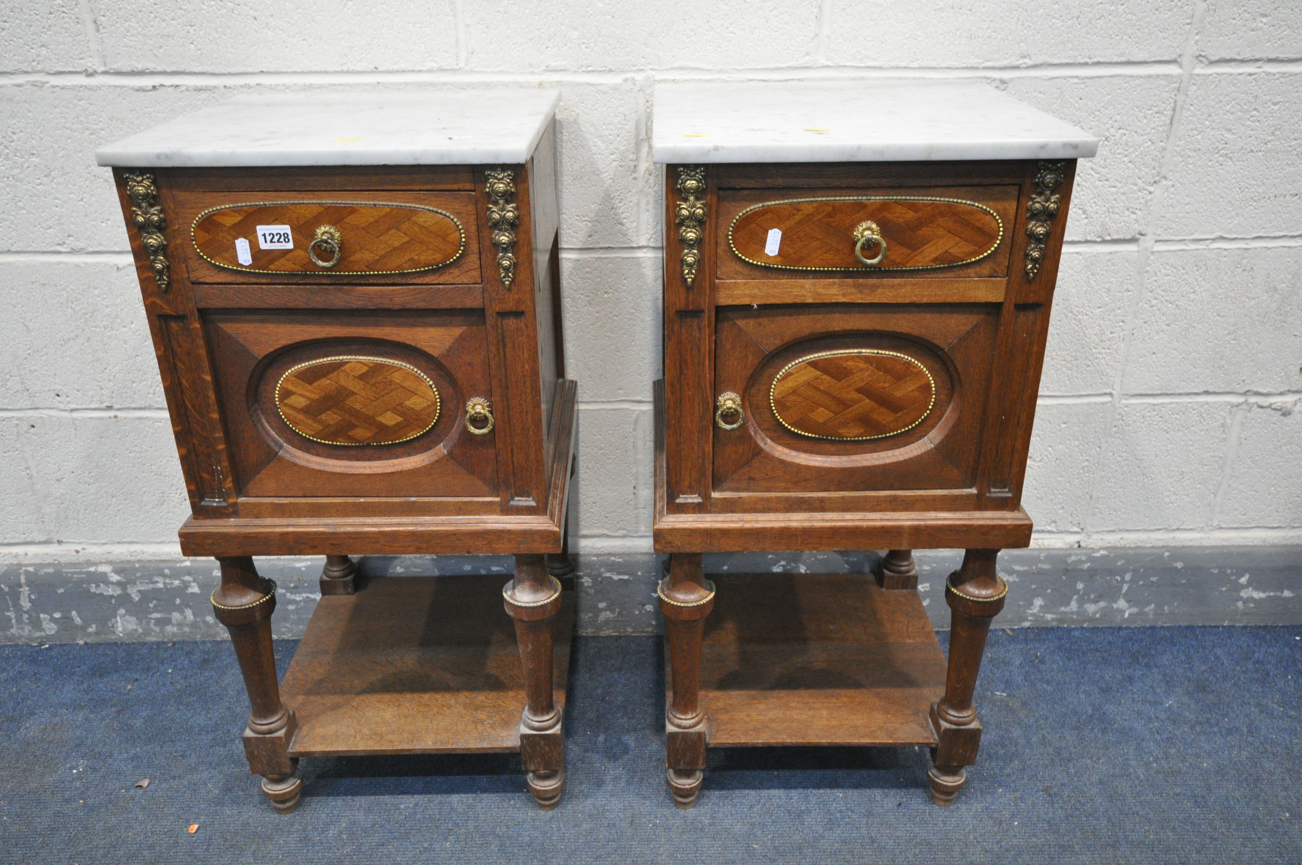 AN OPPOSING PAIR OF EARLY 20TH CENTURY OAK FRENCH POT CUPBOARD/BEDSIDE CABINETS, with marble top,